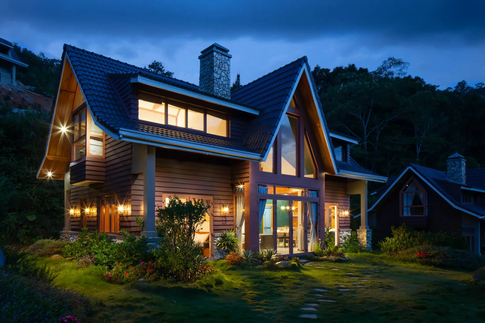 Detached house with garden lighting at dusk