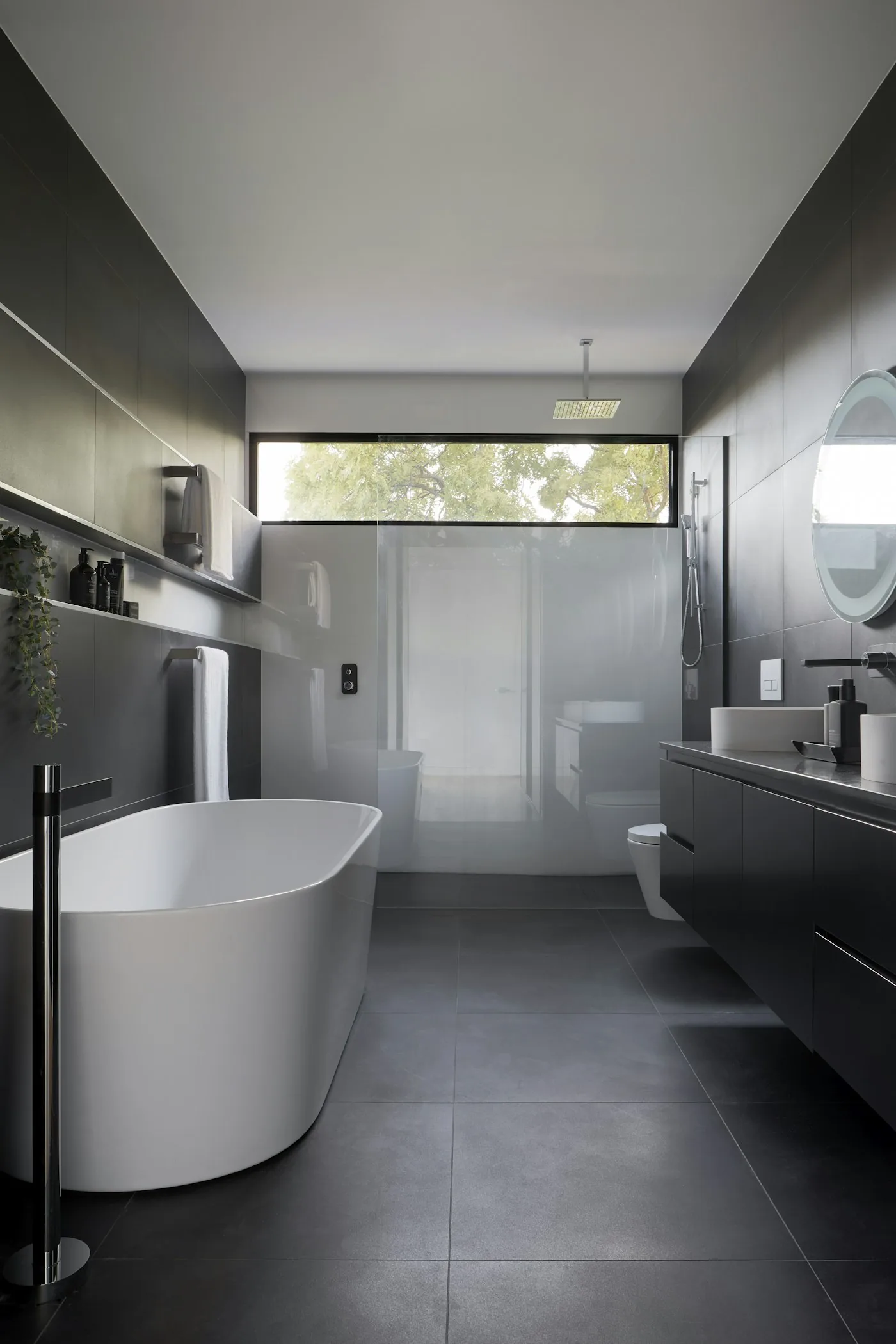 Finished bathroom with a freestanding bath and vanity